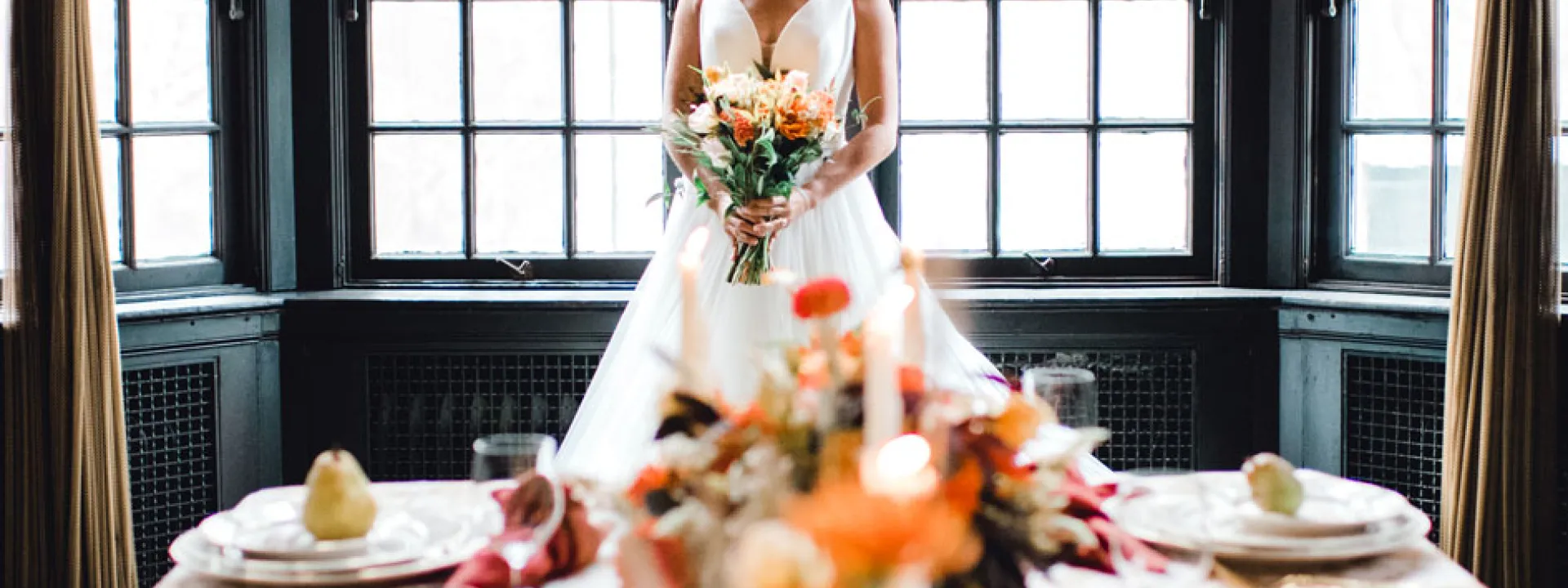 The bride stands at the head of a table bedecked with fall foliage in a grand room at The University Club of Portland