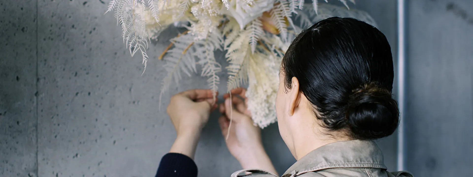 Chas Thompson of Wildflower Portland works with a floral installation of her design. 